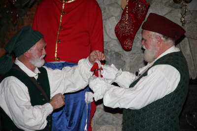 Santa and an elf admiring a toy